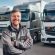 stock-photo-happy-male-truck-driver-front-several-trucks-professional-photography-business-pho_841543-62111